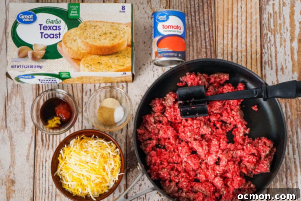 Sloppy Joe Stuffed Garlic Bread 5 Assorted ingredients for Garlic Bread Sloppy Joes laid out: a box of frozen Garlic Texas Toast, a can of condensed tomato soup, bottles of Worcestershire sauce, yellow mustard, and ketchup, small bowls of onion powder, salt, and garlic powder, shredded Colby Jack cheese, and raw ground beef in a black skillet.