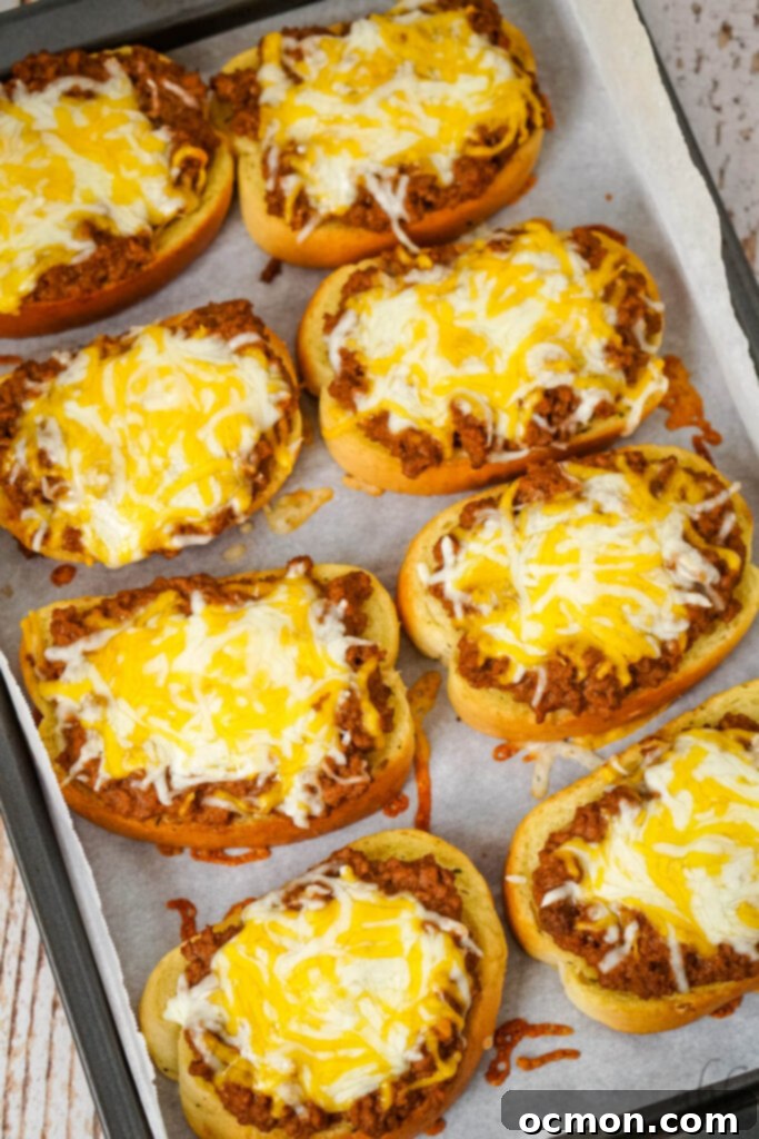 Sloppy Joe Stuffed Garlic Bread 9 A baking tray filled with perfectly finished Garlic Bread Sloppy Joes, each topped with golden, melted Colby Jack cheese and ready to serve.