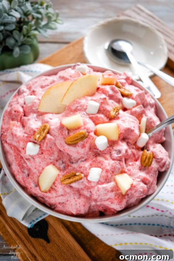A serving bowl of Cranberry Apple Fluff on a tray.