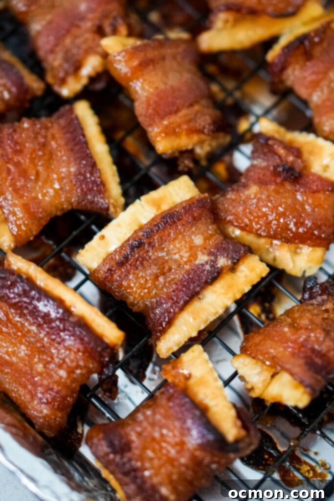 Cajun Caramelized Bacon Cracker Crunch 2 A batch of Cajun Candied Bacon Crackers cooling on a sheet tray, glistening with a sweet and spicy glaze.