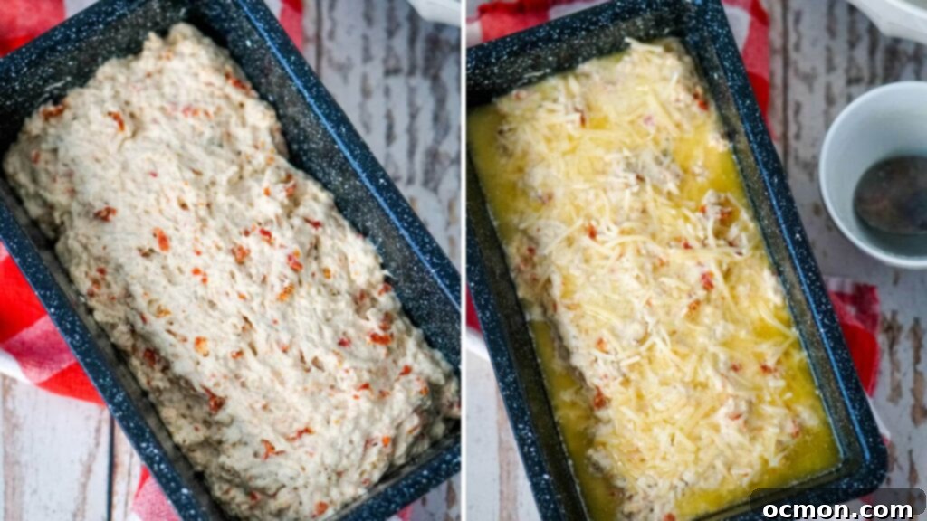 The beer bread batter is carefully poured into a prepared loaf pan, then topped with melted butter and sprinkled with grated Parmesan cheese before baking.