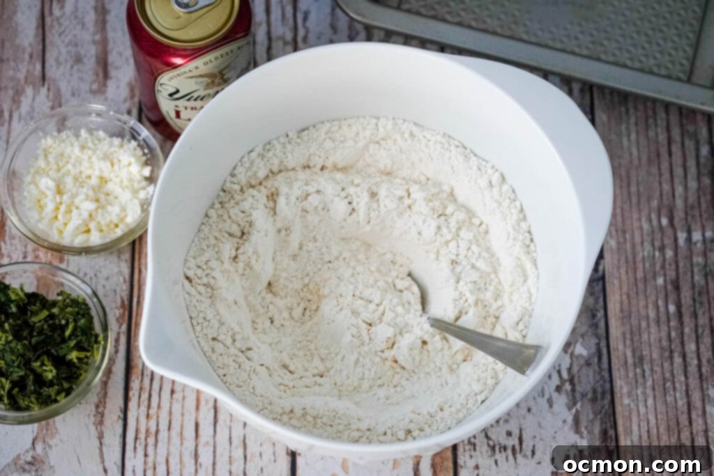 Dry ingredients like flour, sugar, baking powder, salt, garlic powder, and onion powder being mixed in a bowl.