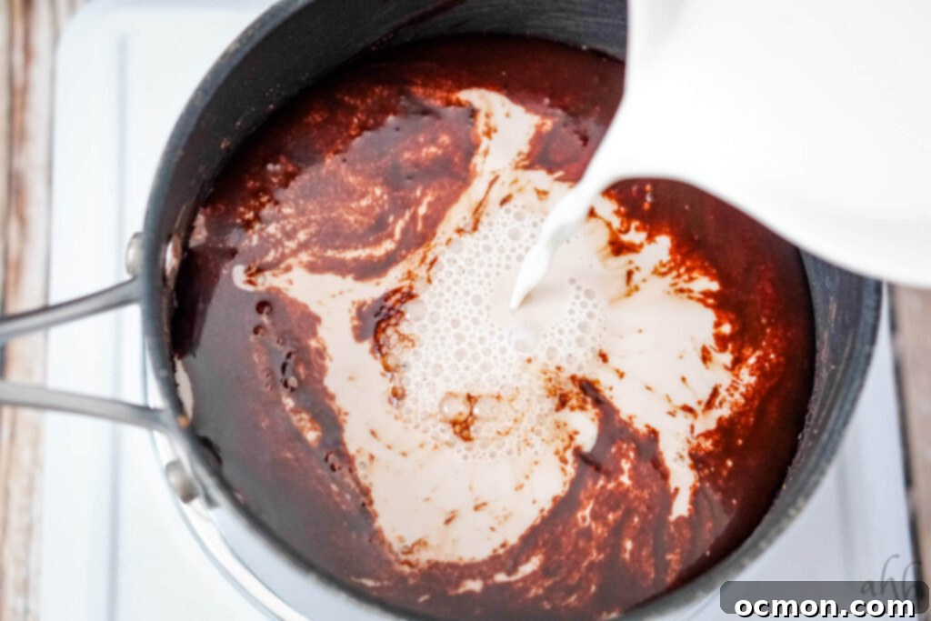 Milk is poured into the sauce pan and mixed with the syrup base. 