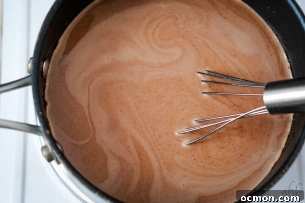 Extract is whisked into the hot chocolate.
