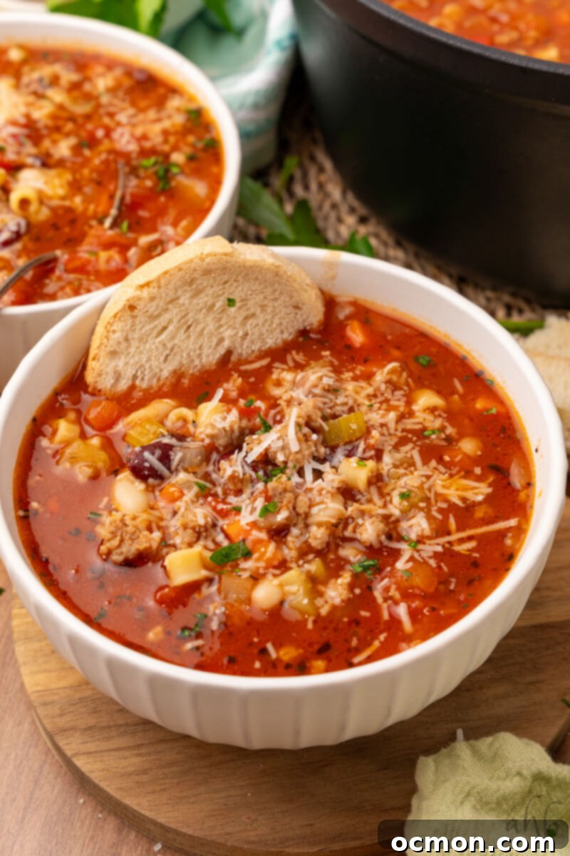 Effortless Sausage Pasta Fagioli 4 Two bowls of Pasta Fagioli are served with a slice of bread.