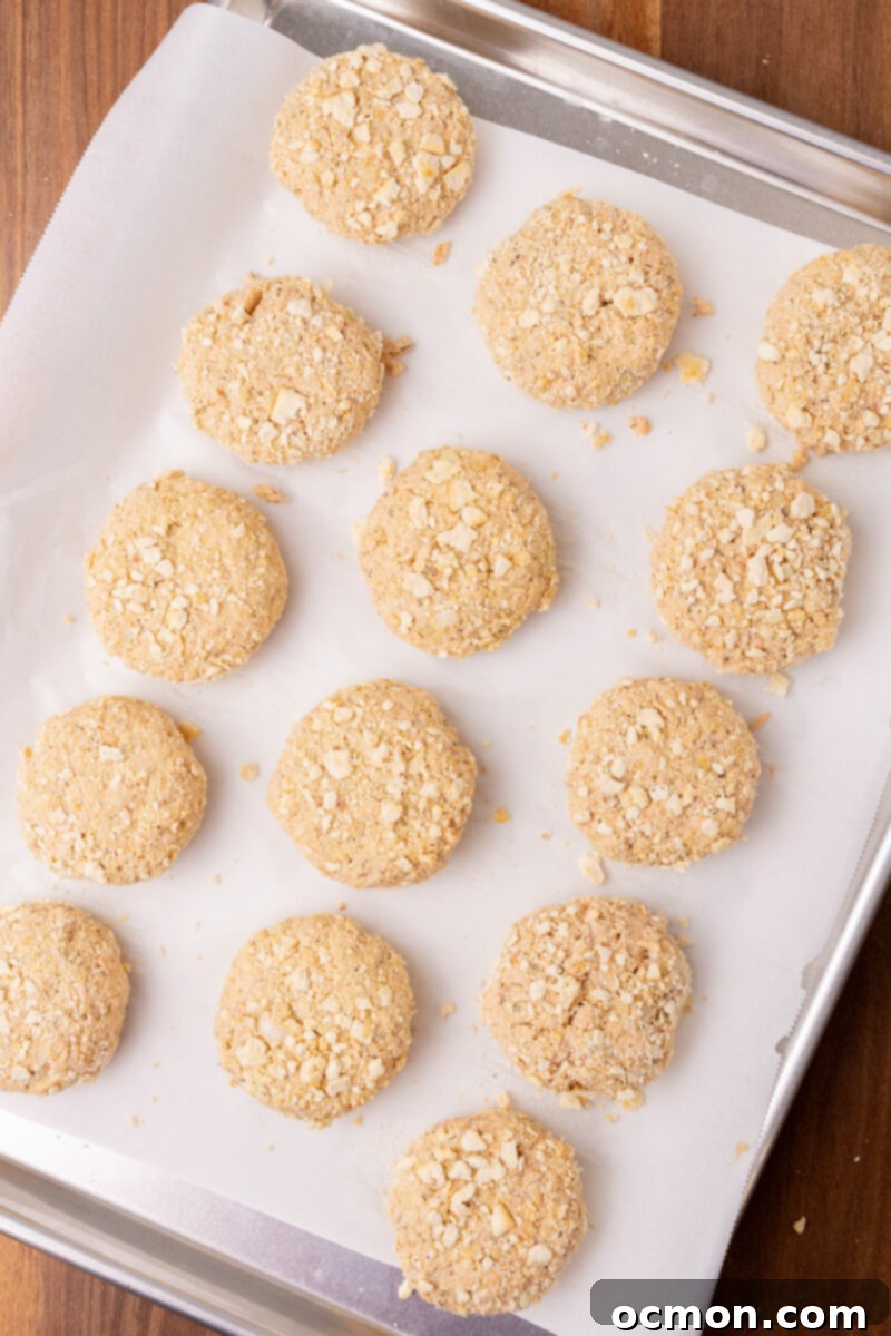 Grandma's Classic Salmon Patties 7 A tray of salmon patties coated in crushed saltine crackers await their turn to fry in the oil.