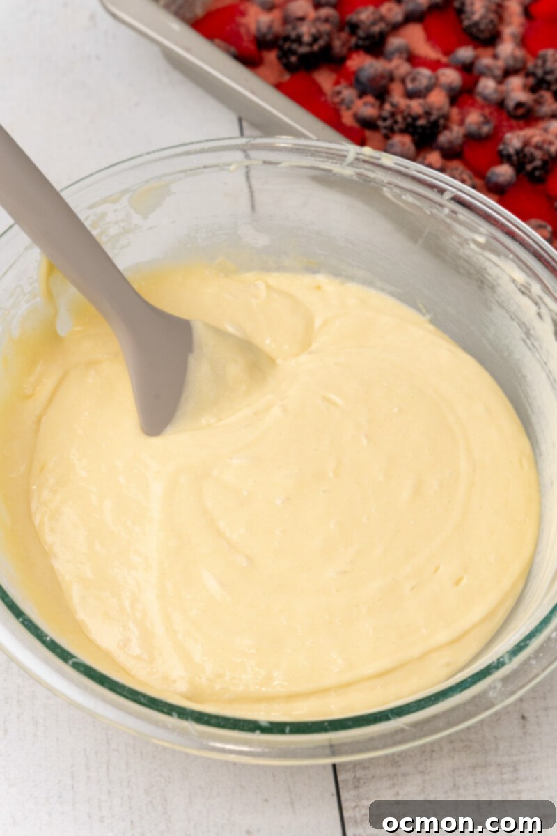 The cake mix and other ingredients are mixed together in a clear bowl.