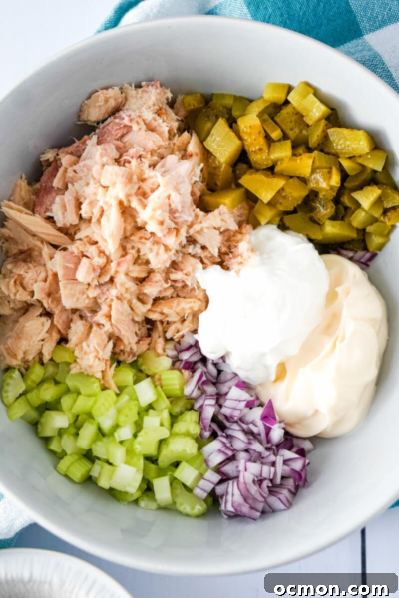 Tangy Dill Pickle Tuna Salad 5 The ingredients for the salad are added to the mixing bowl.