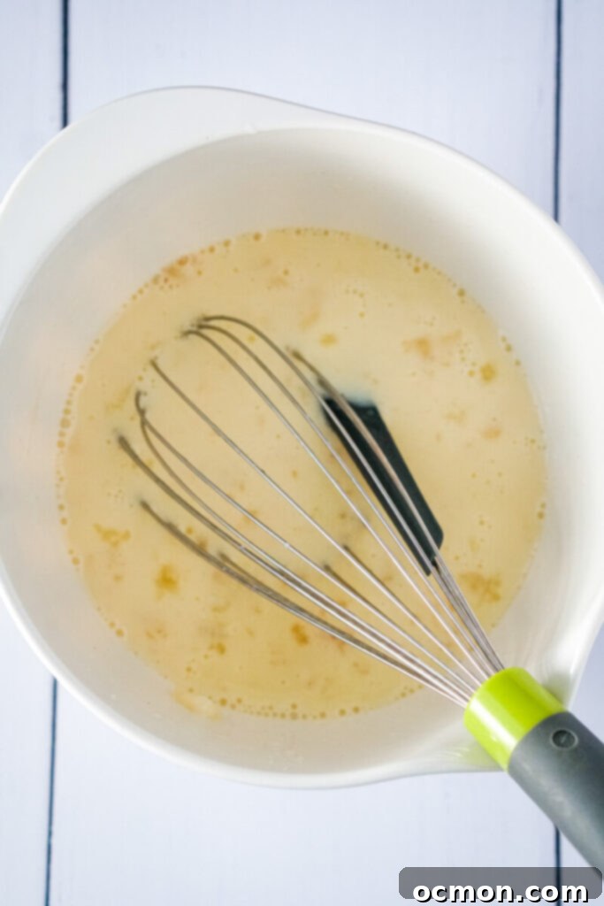 The wet ingredients are mixed in to the pie filling in the white bowl.