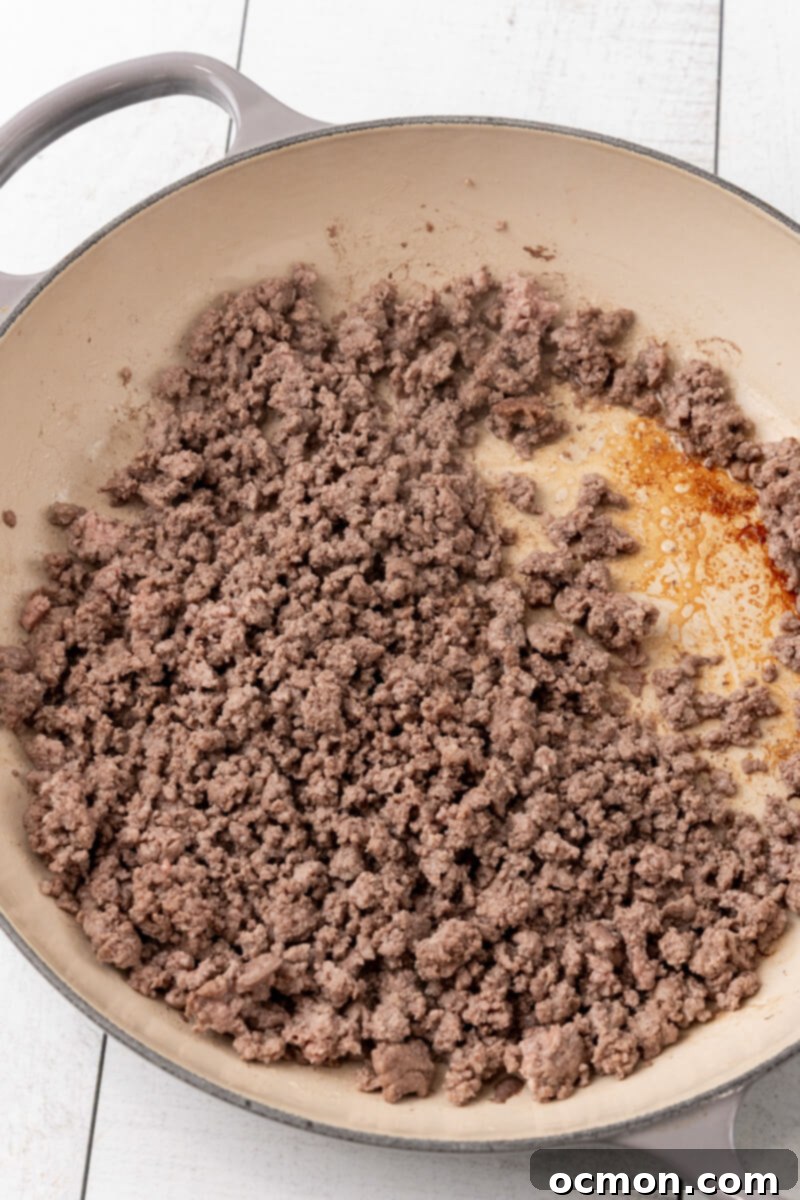 A skillet filled with perfectly browned and thoroughly drained ground beef, ready for the next step in the recipe.