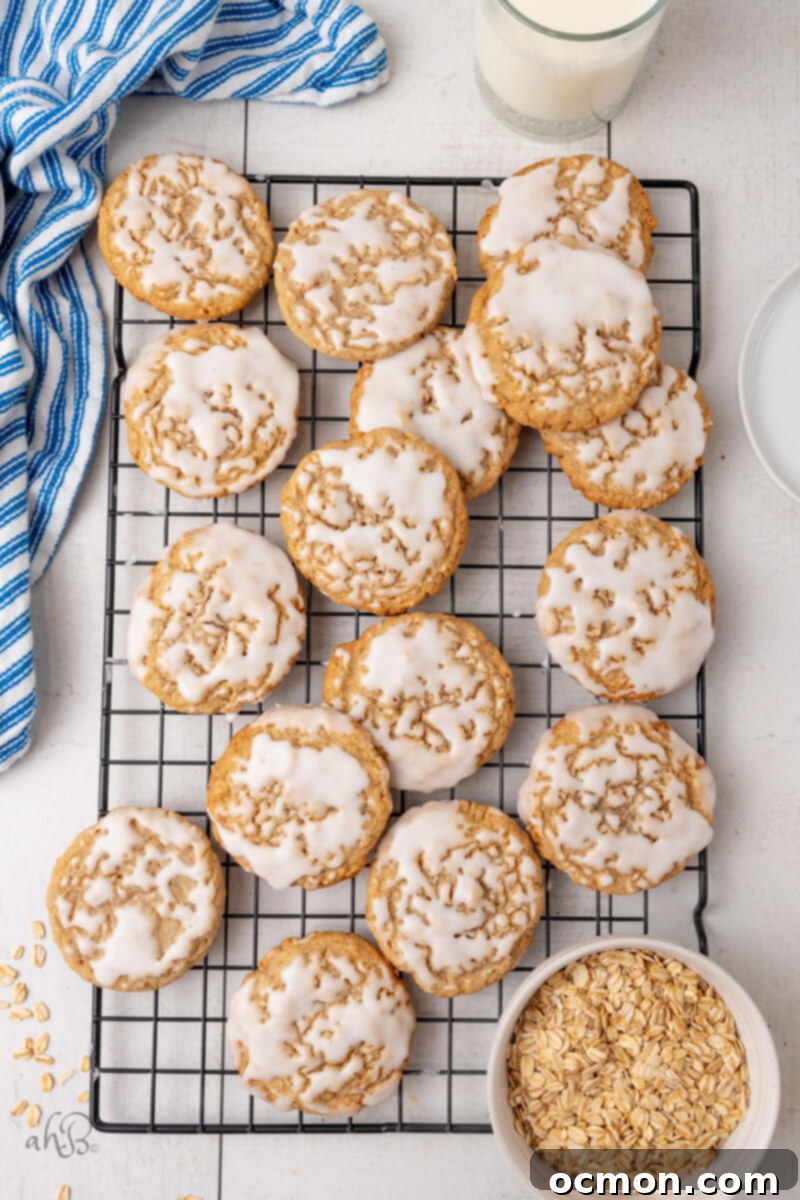 Iced Oatmeal Cookies-11 A large cooling rack filled with freshly baked and iced oatmeal cookies, ready to be enjoyed.