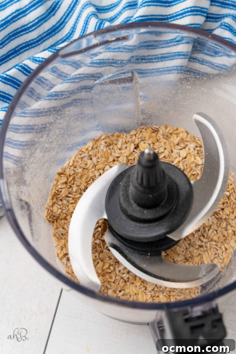 Iced Oatmeal Cookies Step1 A food processor bowl containing partially ground oats, demonstrating the crucial step for achieving the desired cookie texture.