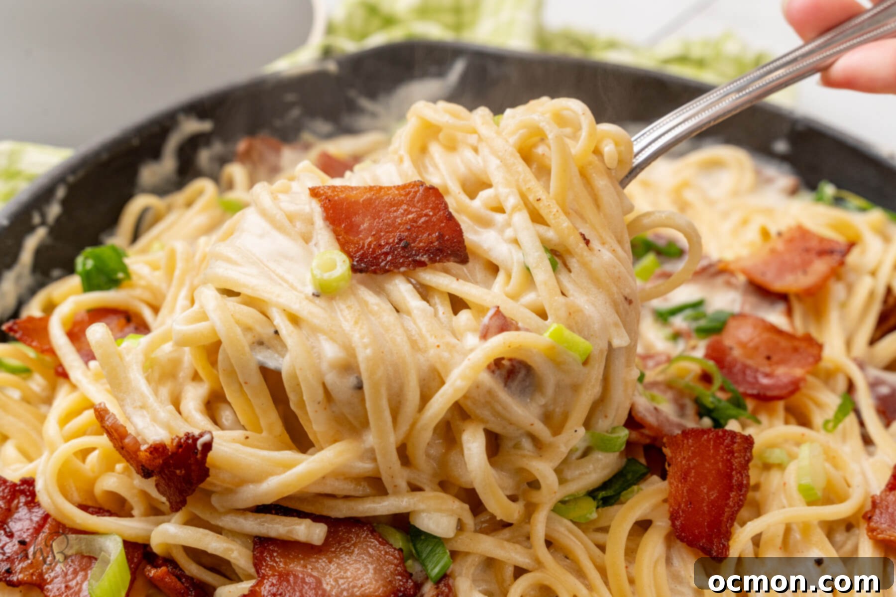 Sour Cream Pasta is scooped out of the skillet with a fork.