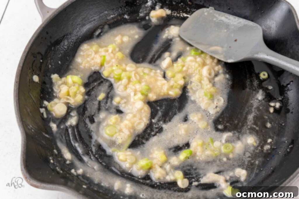 Flour is stirred in to the onions and bacon grease.
