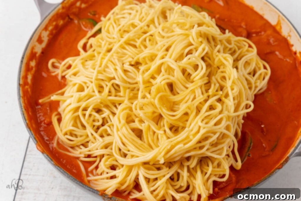 The spaghetti noodles are added to the pot.
