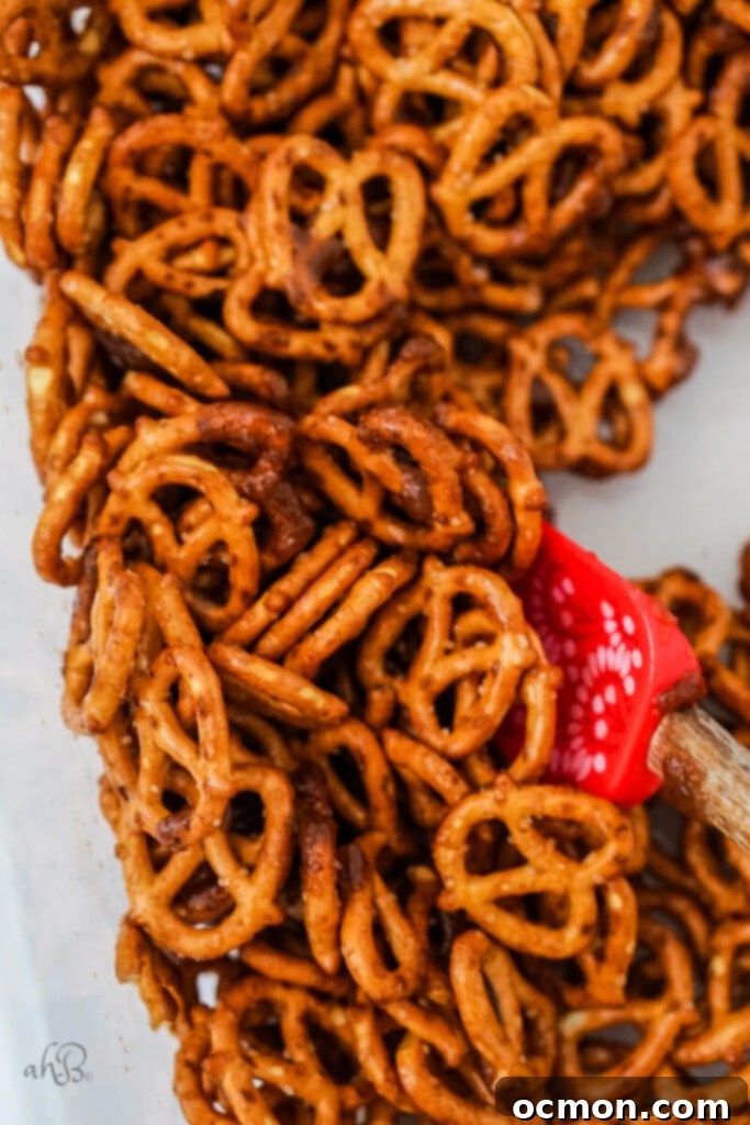 Spiced Apple Cider Pretzels 7 The pretzels are mixed thoroughly with the butter, sugars, corn syrup, and spices in a large bowl, ensuring every piece is coated.