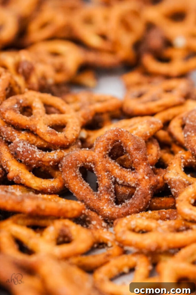 Spiced Apple Cider Pretzels 9 The freshly seasoned pretzels are spread out in a single layer on a parchment-lined baking sheet to cool and dry, preventing sticking and clumping.