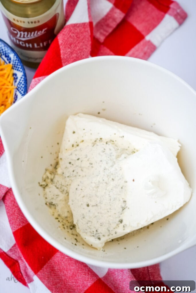 The Ranch Seasoning, cream cheese, and beer are added to a mixing bowl.
