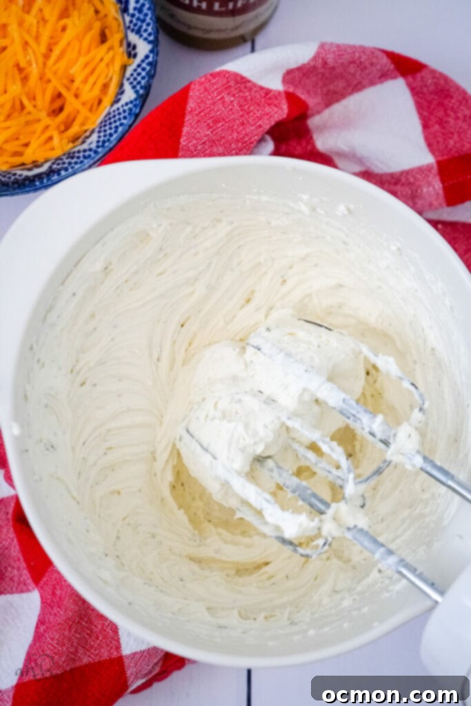 The ingredients are mixed together by an electric handheld mixer.