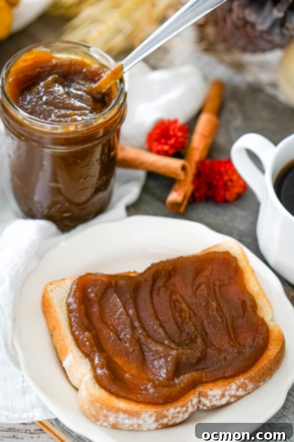 Spiced Pumpkin Delight 5 Freshly made pumpkin butter in a jar with a spoon, showing its rich texture.