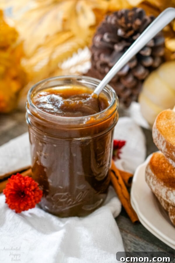 Spiced Pumpkin Delight 7 A jar of homemade pumpkin butter with a spoon in it sitting next to a plate of toast.