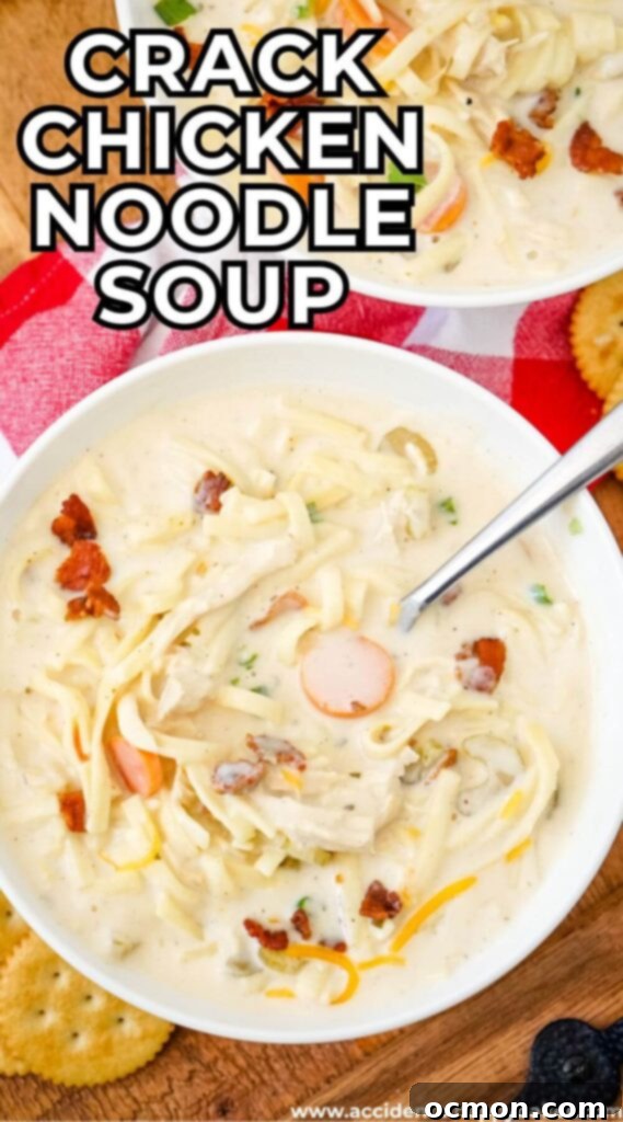 A large, inviting bowl of creamy Crack Chicken Noodle Soup, richly garnished with fresh chives and crispy bacon, emphasizing its comforting and decadent texture, ready to be enjoyed as a hearty meal.