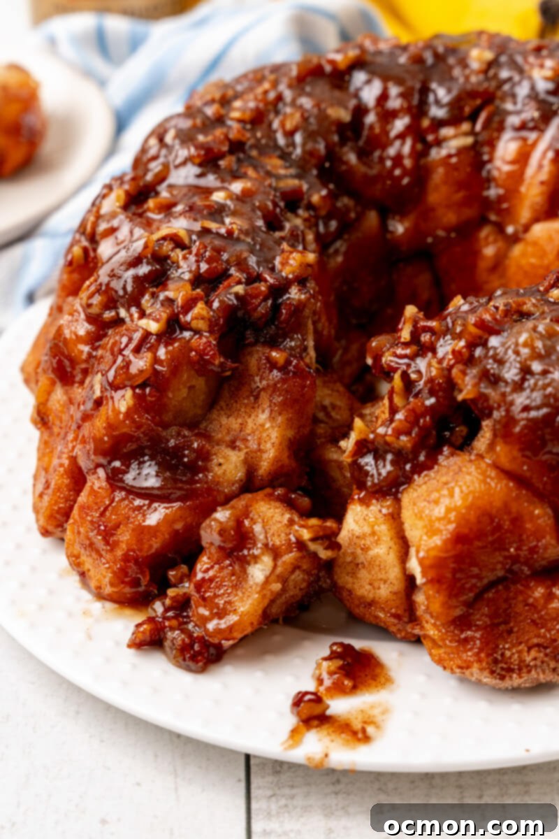 A section of Bananas Foster Monkey Bread has been pulled away, revealing the soft, gooey interior.
