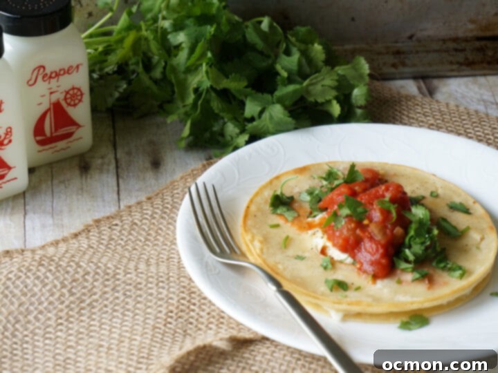 A white plate with a serving of huevo in a hole and salt and pepper shakers to one side. 