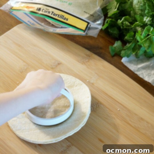 The tortillas are stacked and the centers are cut out with the biscuit cutter. 