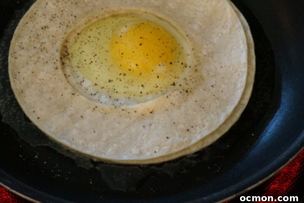 In a skillet, the tortillas and egg are fried together in oil. 