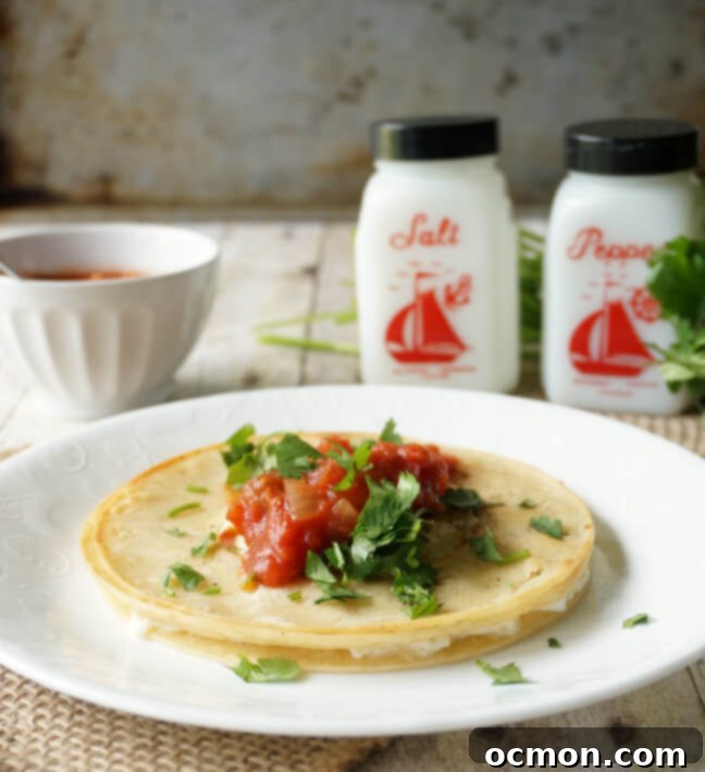 The cooked egg in tortillas is plated and topped with garnishes before serving. 