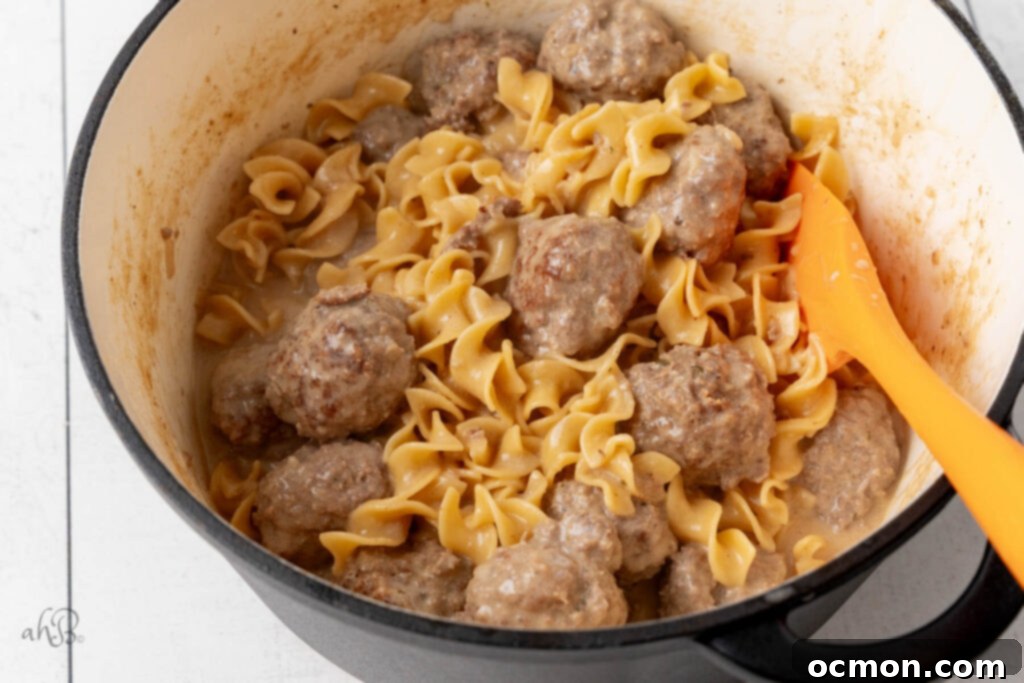 A finished pot of Swedish Meatballs and noodles, steaming and ready to serve.