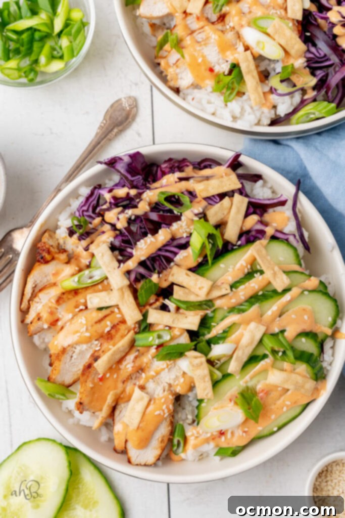 The complete bang bang chicken bowl is served with all the toppings in a white bowl.