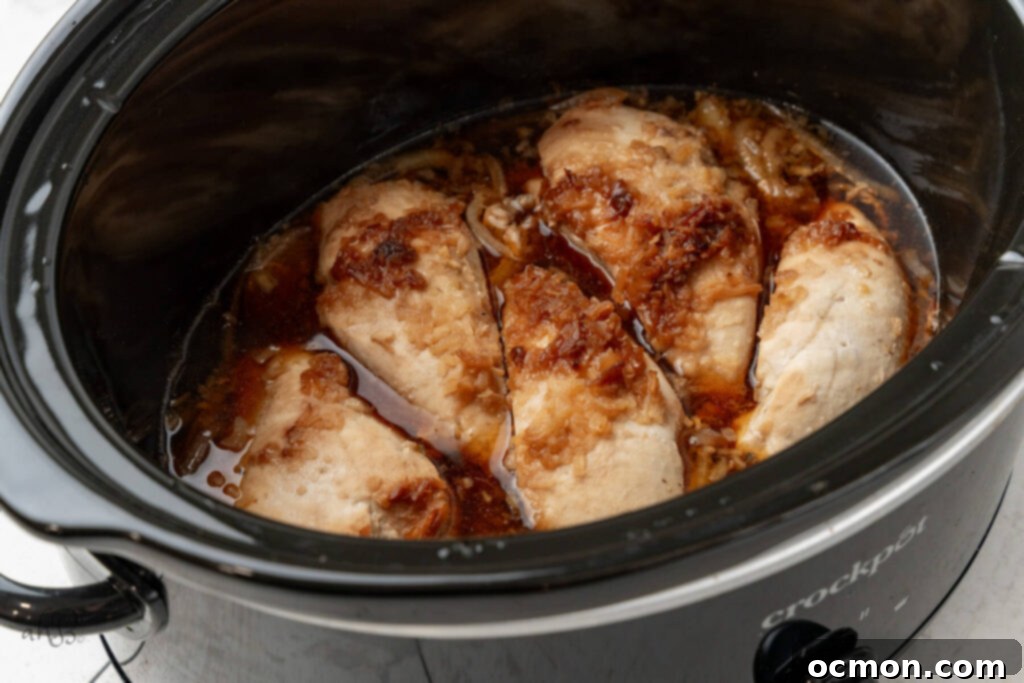 Easy Slow Cooker French Onion Chicken 7 The chicken is cooked in the crockpot.