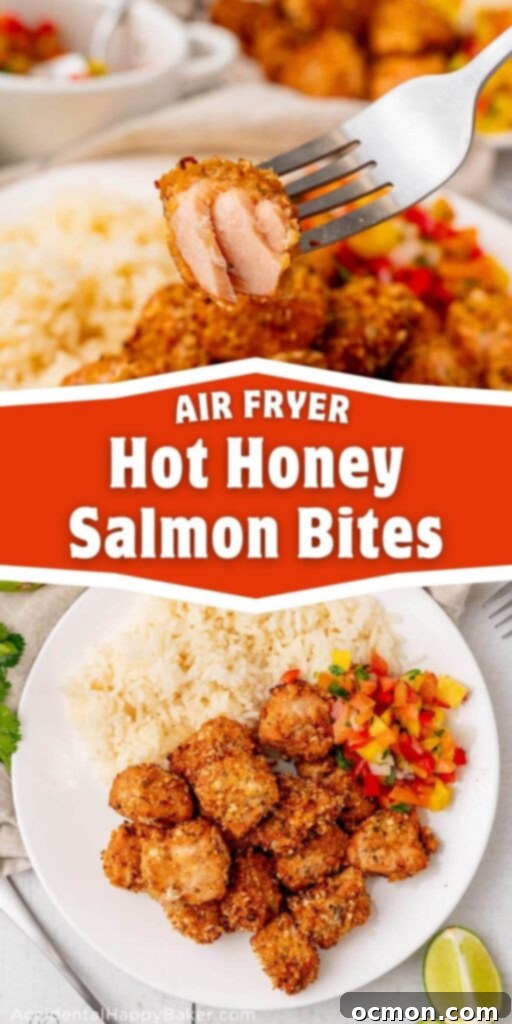 A close-up shot of a single Air Fryer Hot Honey Salmon Bite, perfectly cooked with a crispy golden crust, revealing its flaky and tender pink interior. The bite is artfully placed, highlighting its delicious texture and vibrant color.