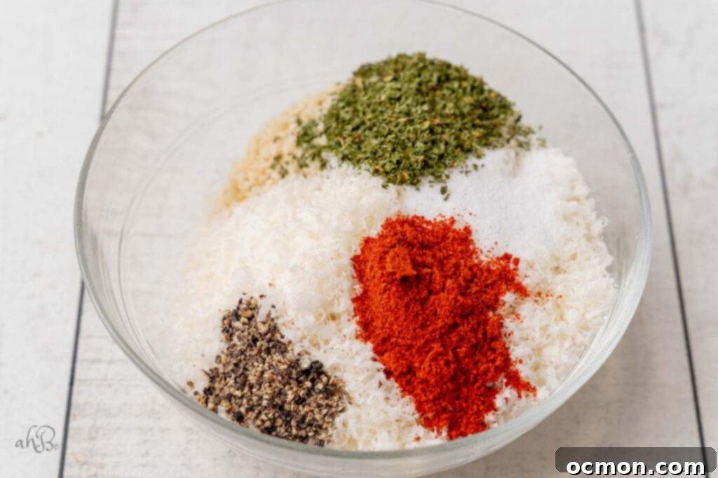 A close-up of a dry mix of panko breadcrumbs, grated parmesan cheese, salt, black pepper, paprika, and dried parsley, perfectly combined in a shallow bowl, ready to coat the marinated salmon.