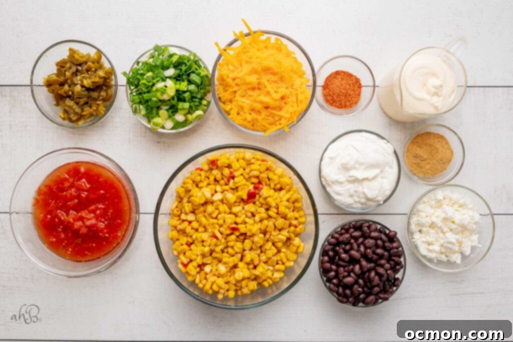 An appetizing ingredient flat lay displaying all the components for Fiesta corn dip: vibrant chopped jalapenos, fresh green onions, shredded cheddar cheese, a shaker of Tajin seasoning, creamy mayonnaise, diced Rotel tomatoes, mexicorn, rich sour cream, a packet of Fiesta ranch dip mix, hearty black beans, and crumbly queso fresca. 