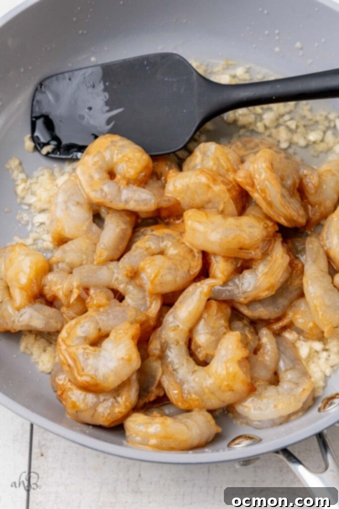 Pour the shrimp and the cornstarch slurry into the pan and cook for one minute on each side. 