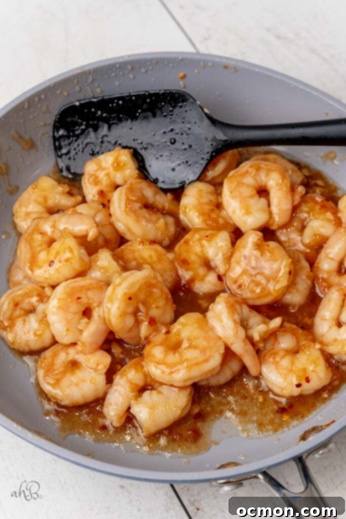 The honey and crushed red pepper are added to the pan as the shrimp finish cooking. 