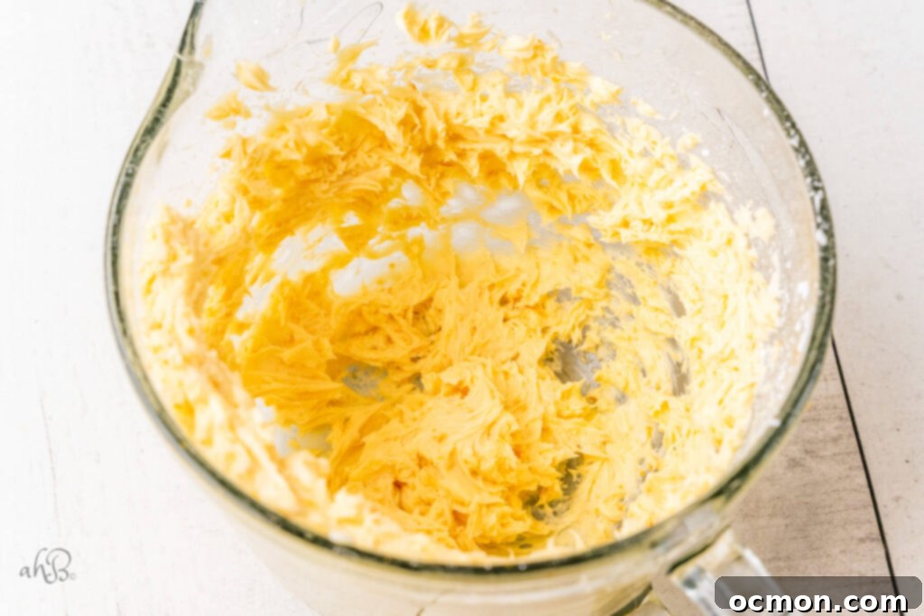 Orange Zest Chocolate Shortbread 6 Softened butter and confectioners sugar expertly blended together in a clear glass measuring bowl, ready for the next steps in the shortbread recipe.