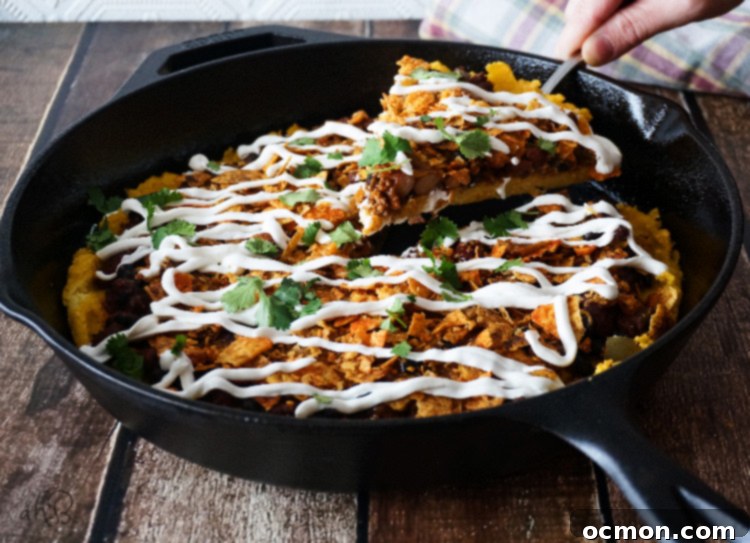 Chili Cheese Polenta; Crispy-edged, creamy-centered polenta topped with chili, cheese, and crunchy crushed nacho chips. No one will ever guess that this chili cheese polenta is a frugal leftover makeover, unless you tell them that is!
