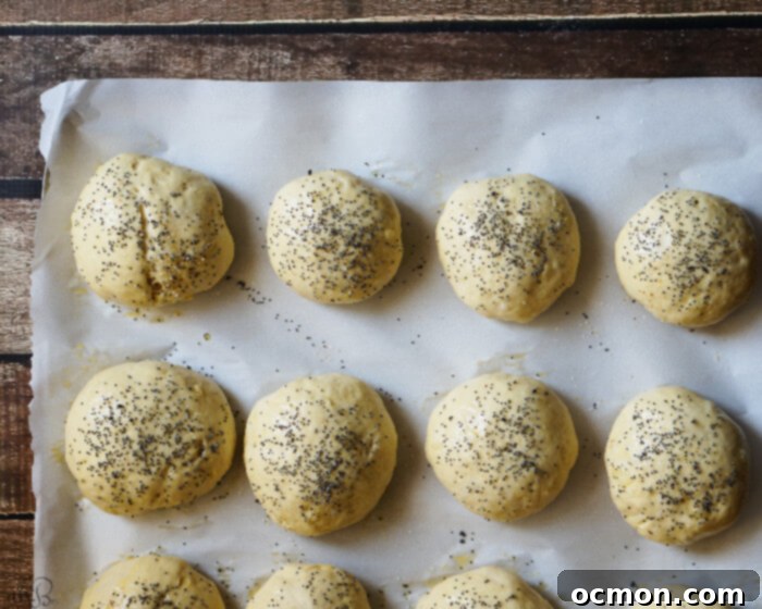 Sweet Onion Rolls 5 Hands kneading dough for Caramelized Onion Buns on a floured wooden surface.