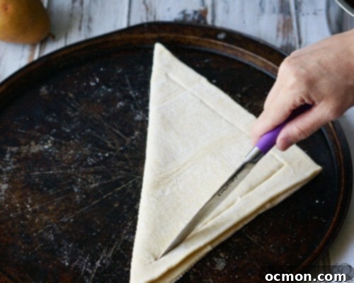 Puff pastry dough being prepared for a galette