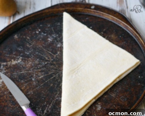 Puff pastry dough being folded for a galette crust