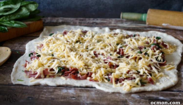 Rolled out bread dough with savory filling for Roast Beef Gouda Rolls