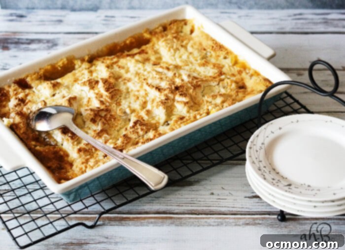 A freshly baked Caramel Apple Dump Cake, still in its 9x13 baking dish, cooling on a wire rack with a golden-brown, bubbly top.