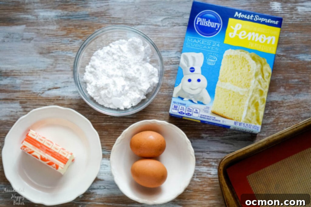 The essential four ingredients laid out for easy Lemon Crinkle Cookies: a box of lemon cake mix, two eggs, a stick of softened butter, and a cup of powdered sugar.