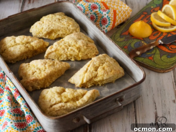 Freshly baked lemon sugar scones with a sweet glaze, perfect for a cozy tea time. Recipe on accidentalhappybaker.com
