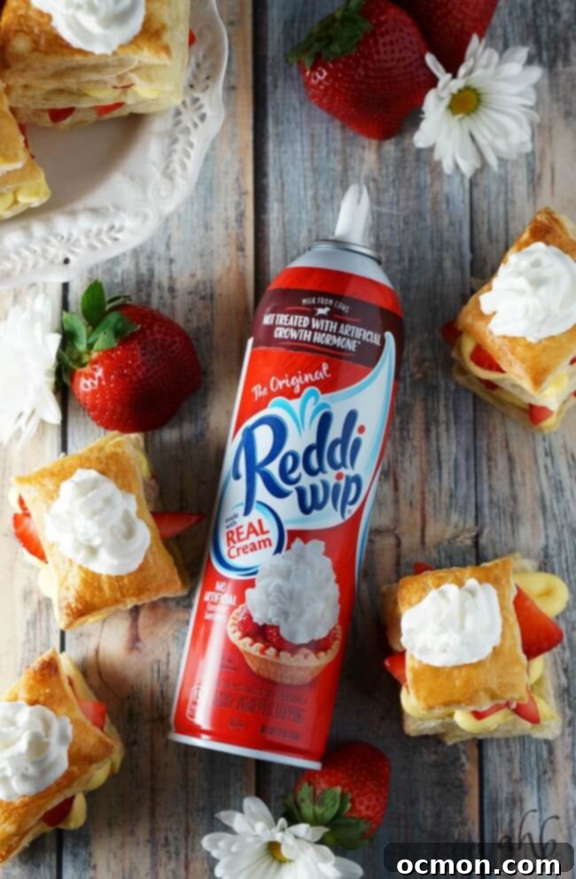 Puff pastry squares on a baking sheet, brushed with egg wash and sugar.