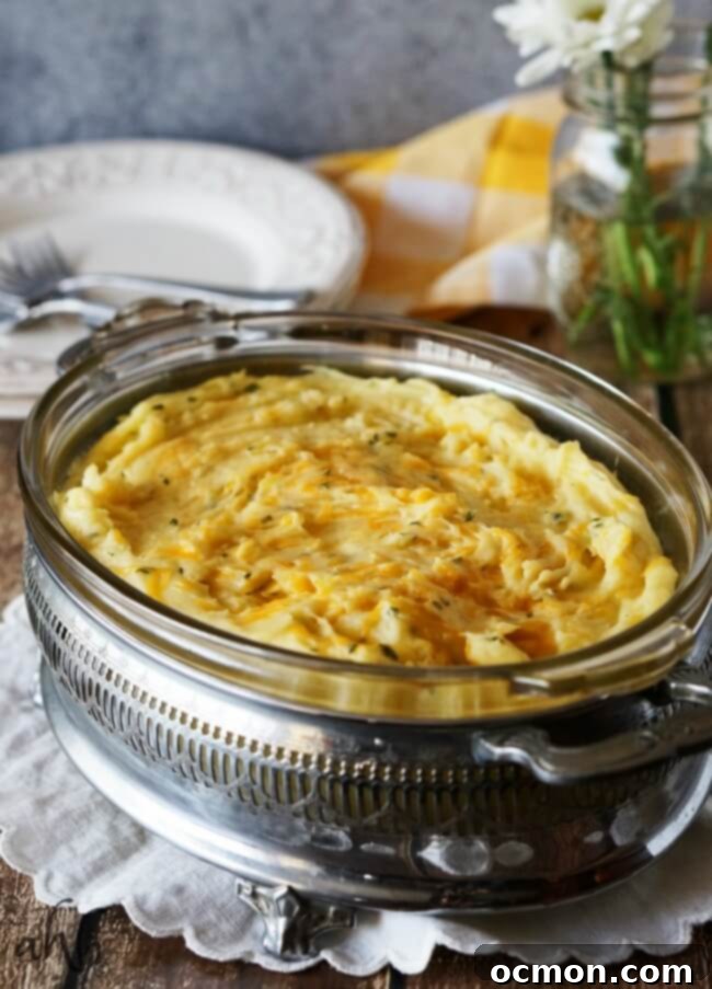 Creamy and fluffy mashed potatoes are taken to the next level of delicious with the addition of sharp cheddar cheese for a side dish everyone will love. Recipe on www.accidentalhappybaker.com @AHBamy